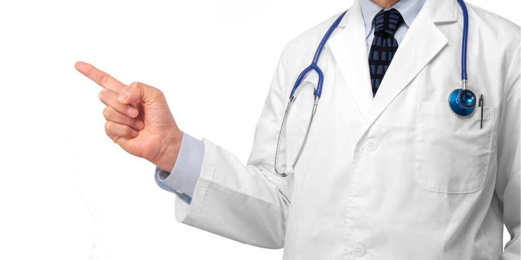 人差し指を立てた医師